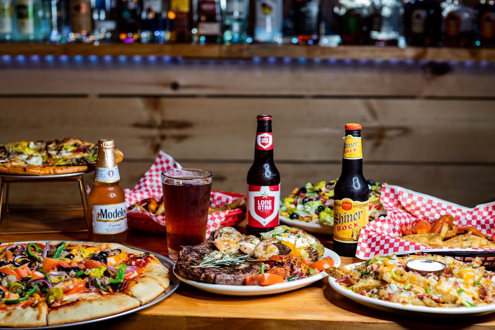 Pizza, steak, and nachos spread at Old 181 Bar and Grill